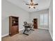 Home office area with carpet, a ceiling fan, wooden bookshelves and a desk at 3004 Fiddler Ct., Loris, SC 29569