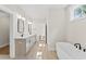 Bright bathroom featuring double sinks, soaking tub, and tiled floors at 348 Autumn Pheasant Loop, Calabash, NC 28467