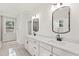 Bright bathroom featuring double sinks, white cabinets, and modern fixtures at 348 Autumn Pheasant Loop, Calabash, NC 28467