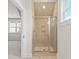 Shower with glass door and built-in niche, complemented by neutral tile and natural light at 348 Autumn Pheasant Loop, Calabash, NC 28467