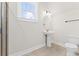 Bright bathroom featuring a pedestal sink, modern lighting, and neutral color palette at 348 Autumn Pheasant Loop, Calabash, NC 28467