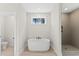 Modern bathroom featuring a free-standing tub and tiled shower with niche at 348 Autumn Pheasant Loop, Calabash, NC 28467