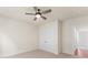 Bedroom featuring plush carpeting, ceiling fan, and large closet space at 348 Autumn Pheasant Loop, Calabash, NC 28467