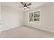 Bedroom with plush carpeting, ceiling fan, and a large window showcasing backyard views at 348 Autumn Pheasant Loop, Calabash, NC 28467