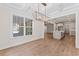 Bright dining room with new light fixture, hardwood floors, and scenic view at 348 Autumn Pheasant Loop, Calabash, NC 28467