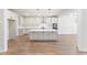 Bright kitchen with large island, stainless appliances, and hardwood floors at 348 Autumn Pheasant Loop, Calabash, NC 28467