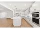 Open kitchen featuring a large island, stainless steel appliances, and hardwood floors at 348 Autumn Pheasant Loop, Calabash, NC 28467