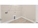 Neutral laundry room showcasing tile flooring, utility connections, and overhead storage shelf at 348 Autumn Pheasant Loop, Calabash, NC 28467