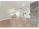 Open-concept living room showcasing the modern kitchen and stone fireplace at 348 Autumn Pheasant Loop, Calabash, NC 28467