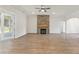 Bright and airy living room featuring hardwood floors, a stone fireplace and backyard views at 348 Autumn Pheasant Loop, Calabash, NC 28467