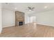 Spacious living room featuring hardwood floors, a fireplace and an arched doorway at 348 Autumn Pheasant Loop, Calabash, NC 28467