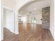 Open-concept living room with hardwood floors and a stone fireplace at 348 Autumn Pheasant Loop, Calabash, NC 28467