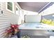 Backyard hot tub featuring retractable awning and exterior wall detailing at 402 Bumble Circle, Murrells Inlet, SC 29576