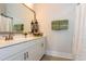 Bathroom with a vanity, quartz countertops, an oversized mirror, and brushed nickel fixtures at 402 Bumble Circle, Murrells Inlet, SC 29576