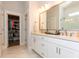 Bright bathroom features a double sink vanity and a large closet with shelving at 402 Bumble Circle, Murrells Inlet, SC 29576