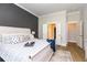Bright bedroom with a modern rustic bed, blue accents, and ensuite bath and closet doors at 402 Bumble Circle, Murrells Inlet, SC 29576