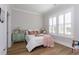 Bedroom boasts white shutters, decorative pillows, side tables, and accent furniture at 402 Bumble Circle, Murrells Inlet, SC 29576
