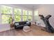 Sun-filled bonus room with a couch, natural light, and a treadmill for exercise at 402 Bumble Circle, Murrells Inlet, SC 29576