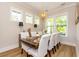Bright dining room with modern light fixture, table set for six, and lots of light at 402 Bumble Circle, Murrells Inlet, SC 29576