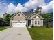 Charming single-story home featuring a two-car garage and well-manicured lawn at 402 Bumble Circle, Murrells Inlet, SC 29576