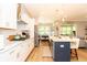 Open-concept kitchen with marble counters and stainless appliances, view to living area at 402 Bumble Circle, Murrells Inlet, SC 29576