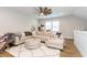 Spacious living room boasts large sectional sofa, ottoman, and hardwood floors at 402 Bumble Circle, Murrells Inlet, SC 29576
