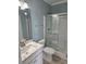 Bright bathroom featuring a vanity with quartz countertop and shower with glass door at 4831 Riverside Dr., North Myrtle Beach, SC 29582