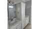 Bathroom featuring double sinks, quartz countertop, and linen cabinet at 4831 Riverside Dr., North Myrtle Beach, SC 29582
