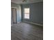 Bedroom featuring hardwood floors, blue walls, and a window at 4831 Riverside Dr., North Myrtle Beach, SC 29582