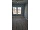 Bedroom featuring hardwood floors, blue walls, and a window with a neighborhood view at 4831 Riverside Dr., North Myrtle Beach, SC 29582
