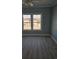 Bedroom with blue walls, fan, and window views at 4831 Riverside Dr., North Myrtle Beach, SC 29582