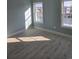 Bright bedroom featuring pale blue walls, wood floors, and two windows inviting natural light at 4831 Riverside Dr., North Myrtle Beach, SC 29582