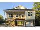 New construction home featuring a raised foundation, front porch, and garage at 4831 Riverside Dr., North Myrtle Beach, SC 29582