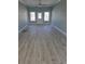 Bright living room with light blue walls, fan, and wood-look flooring at 4831 Riverside Dr., North Myrtle Beach, SC 29582
