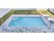 Aerial view of a pristine rectangular pool surrounded by a gray brick patio and green lawn at 4831 Riverside Dr., North Myrtle Beach, SC 29582
