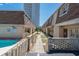 View of the building exterior with brick accents, manicured grounds, and a visible pool area at 5508 Porcher Dr. # 3, Myrtle Beach, SC 29577