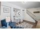Bright living room with stylish décor, breakfast bar, and staircase featuring hardwood floors at 5508 Porcher Dr. # 3, Myrtle Beach, SC 29577