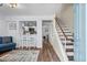 View of living room, breakfast bar, and staircase with hardwood floors and stylish decor at 5508 Porcher Dr. # 3, Myrtle Beach, SC 29577