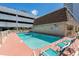 Resort-style community pool with chairs for sunbathing, ideal for summer relaxation at 5508 Porcher Dr. # 3, Myrtle Beach, SC 29577