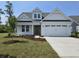 Charming single-Gathering home with a two-car garage, manicured lawn, and beautiful landscaping at 708 Lapwind Loop, Myrtle Beach, SC 29579
