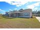 Spacious backyard featuring a screened porch, ideal for outdoor relaxation and entertaining guests at 8723 Baton Rouge Ave Nw, Calabash, NC 28467