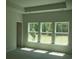 Bright bedroom with three large windows offering a green view at 8743 Baton Rouge Ave Nw, Calabash, NC 28467
