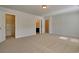 Spacious, carpeted bedroom with multiple doors leading to closet and bathroom at 8743 Baton Rouge Ave Nw, Calabash, NC 28467