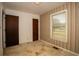 A bedroom with wallpapered accent wall, a window, and closet doors, providing a sense of the room's character at 1001 Creel St., Conway, SC 29527