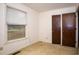 A bedroom featuring a window with blinds and closet doors, showcasing the room's natural light and storage at 1001 Creel St., Conway, SC 29527