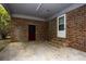 A spacious carport with a brick wall and a door leading to the backyard at 1001 Creel St., Conway, SC 29527