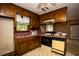 The kitchen features wood cabinets, a compact oven, and classic-style appliances at 1001 Creel St., Conway, SC 29527