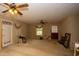 The spacious living room features ceiling fans, a rear door, and natural light from the windows at 1001 Creel St., Conway, SC 29527