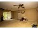Spacious living area with sliding glass doors, ceiling fans, and classic floral curtains at 1001 Creel St., Conway, SC 29527