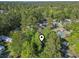 Aerial view of a cozy gray mobile home nestled among the trees in a peaceful community at 103 Off Shore Dr., Murrells Inlet, SC 29576